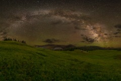 Milkyu Way over green mountain valley